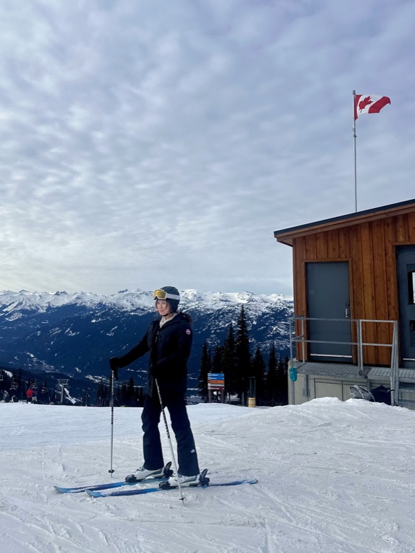 Stella on skis at the top of a mountain