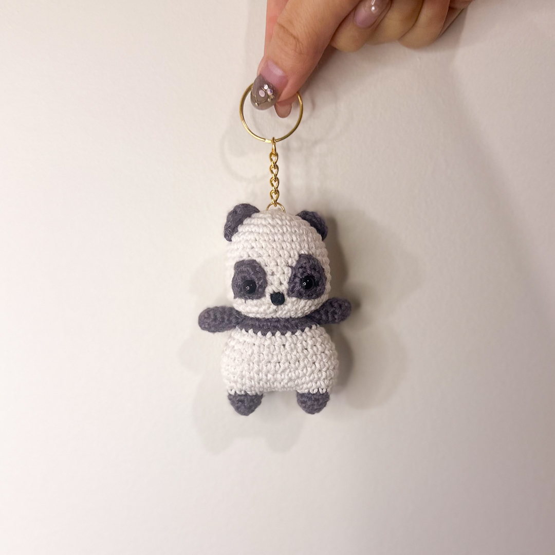 Panda keychain held in hand
