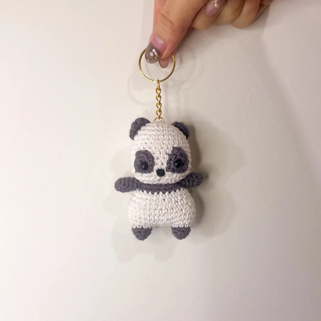 Panda keychain held in hand