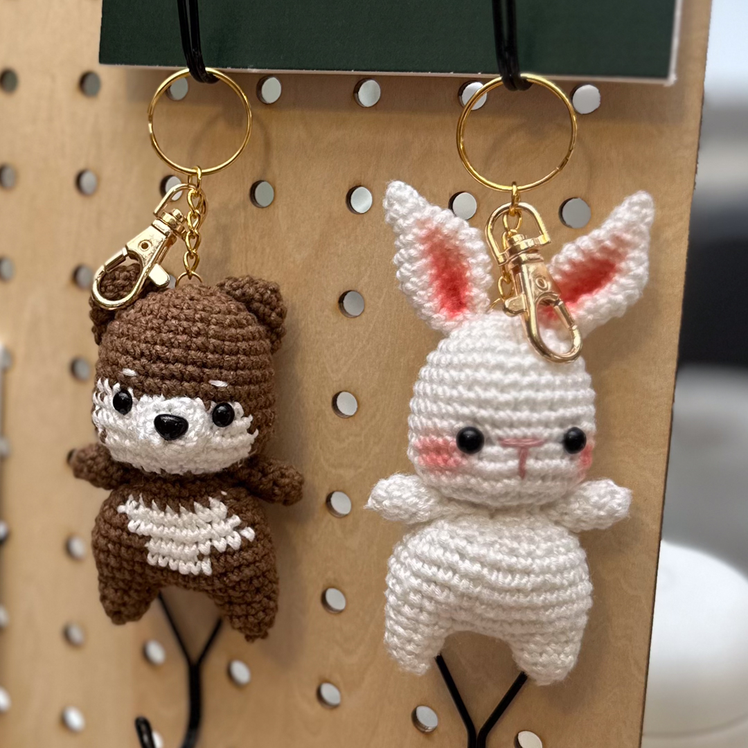 Bear and bunny keychains hanging on a pegboard display